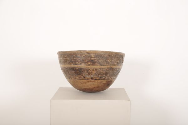 A LARGE DUG OUT WOODEN BOWL