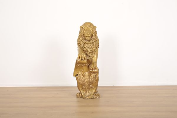 A GILT PLASTER STANDING LION