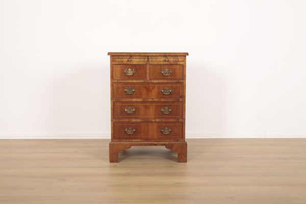 A SMALL FIGURED WALNUT CHEST OF DRAWERS