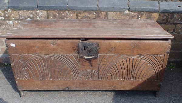 A SMALL OAK COFFER WITH NAIVELY CARVED ARCADED FRONT