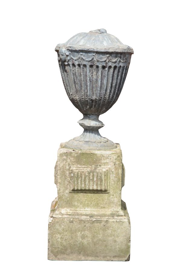 A LEAD CLASSICAL URN ON STONE STAND