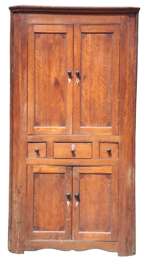 A GEORGE III PROVINCIAL OAK CORNER CUPBOARD