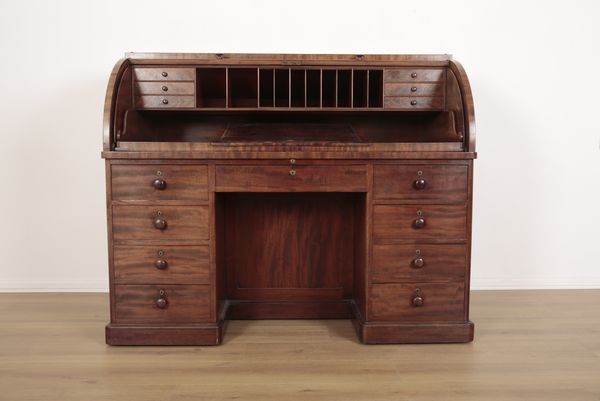 AN EARLY VICTORIAN FIGURED MAHOGANY CYLINDER DESK