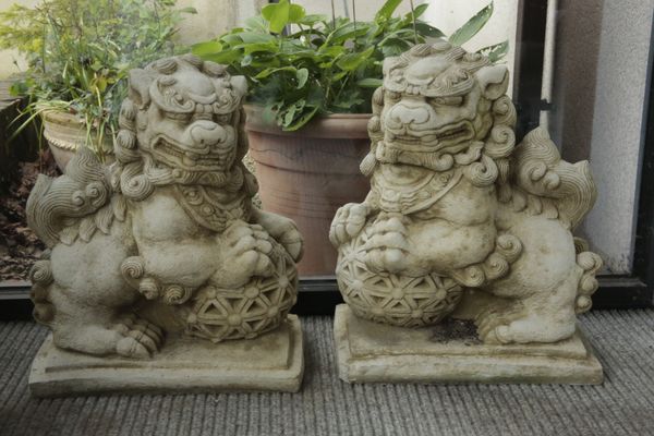 A PAIR OF CHINESE STYLE COMPOSITE STONE LION DOGS OR TEMPLE GUARDIANS