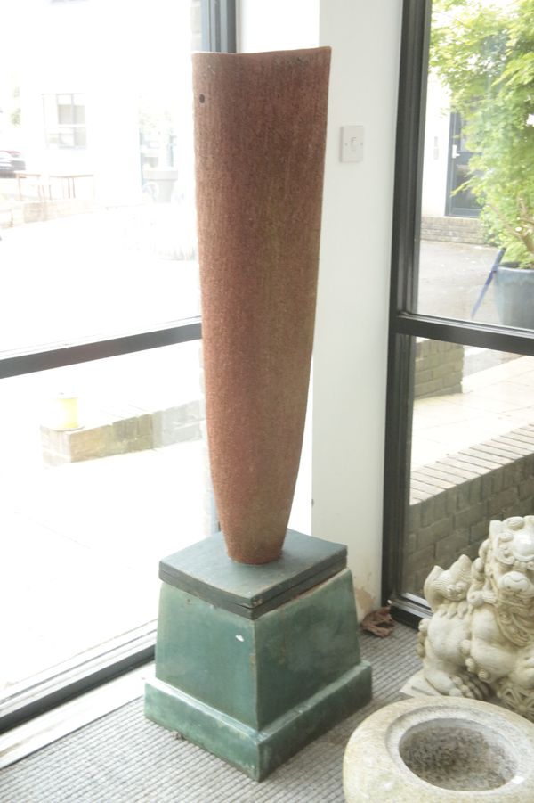 A TEXTURED ABSTRACT TERRACOTTA GARDEN SCULPTURE