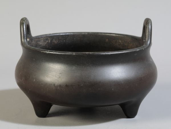 A CHINESE BRONZE TRIPOD CENSER
