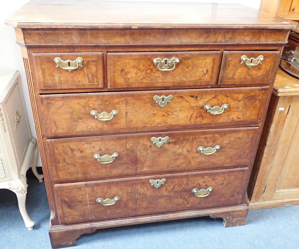 A GEORGE III FIGURED WALNUT CHEST OF DRAWERS