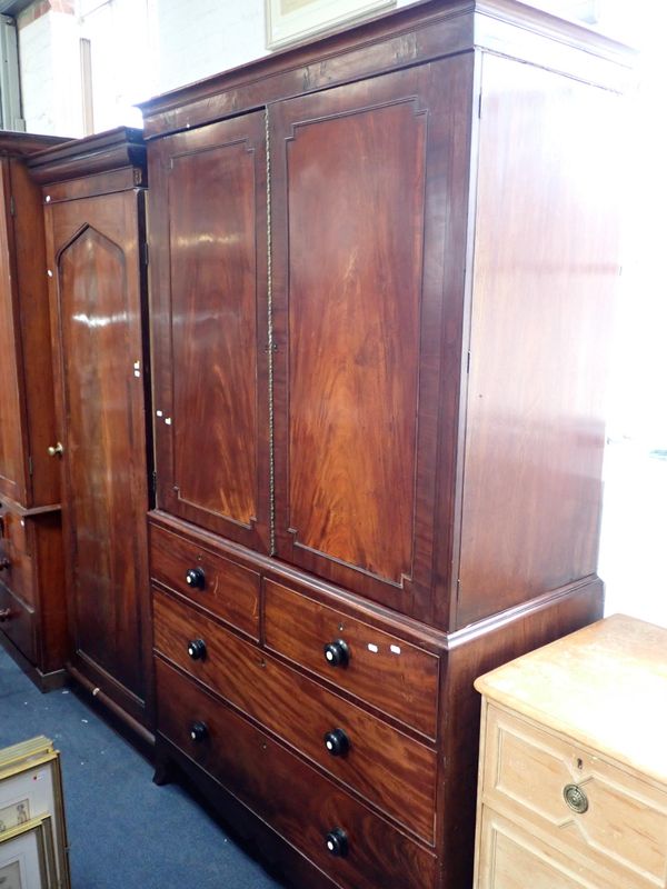 A GEORGE IV FIGURED MAHOGANY LINEN PRESS