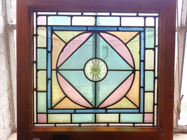 A COLOURED LEADED GLASS PANEL, WITH  WHORLED BULLSEYE CENTRE