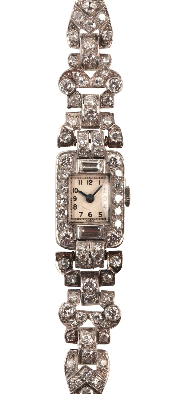 A LADY'S DIAMOND AND PLATINUM COCKTAIL WATCH