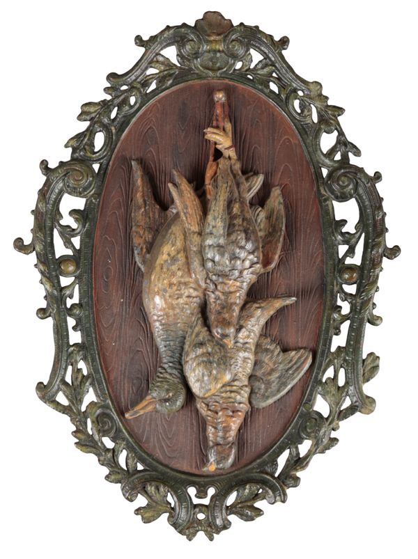 A PAINTED BRONZE AND CAST IRON WALL PLAQUE OF HANGING GAME