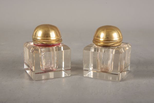 A PAIR OF BRASS AND GLASS INKWELLS