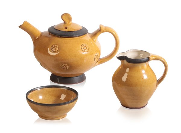 *RICHARD WILSON FOR LE DIEU POTTERY: A YELLOW GLAZE TEAPOT, JUG AND SUGAR BOWL