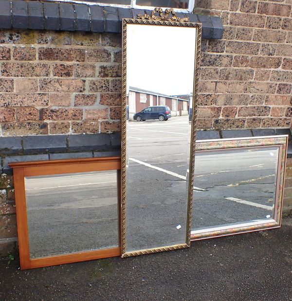 A GILT FRAMED LONG WALL MIRROR