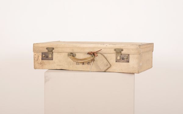 AN EARLY 20TH CENTURY VELLUM SUITCASE