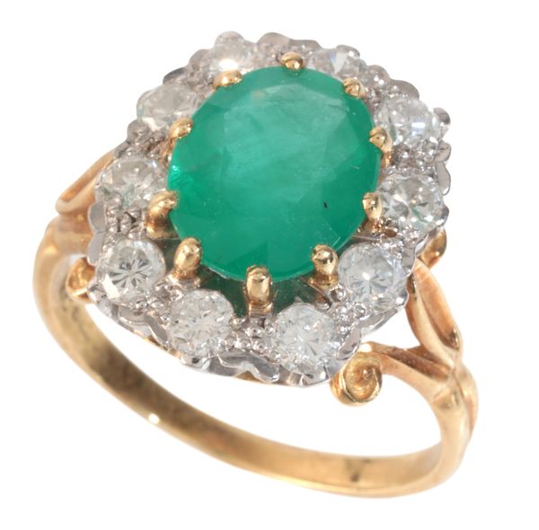 AN EMERALD AND DIAMOND CLUSTER RING