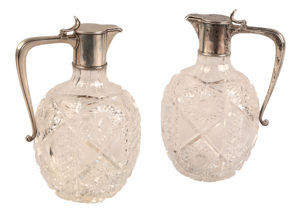 FABERGÉ: A PAIR OF EARLY 20TH CENTURY RUSSIAN SILVER MOUNTED CUT GLASS CLARET JUGS