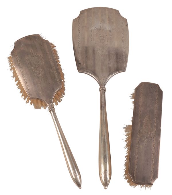 A GEORGE V SILVER-BACKED THREE PIECE DRESSING TABLE SET