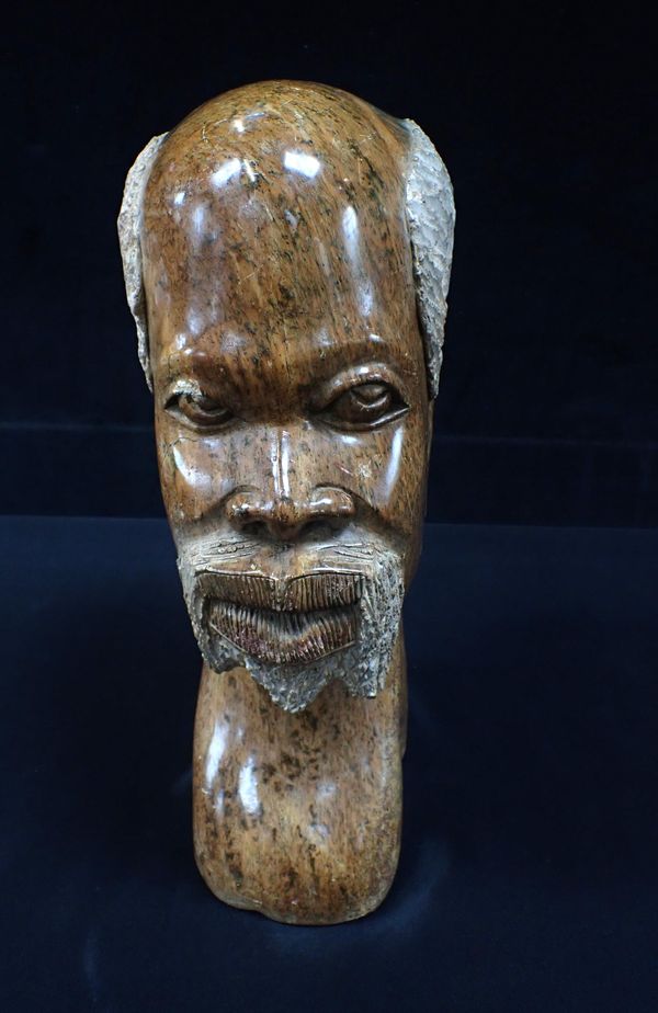 AN AFRICAN CARVED AND POLISHED STONE HEAD