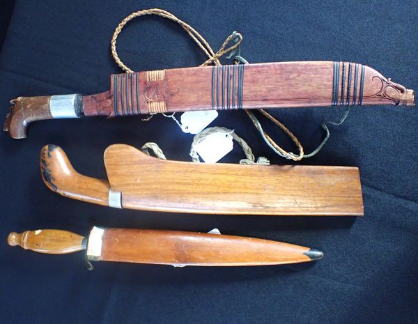 THREE KUKRIS IN WOODEN SCABBARDS