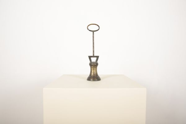 A BRASS VICTORIAN BELL-SHAPED DOOR PORTER