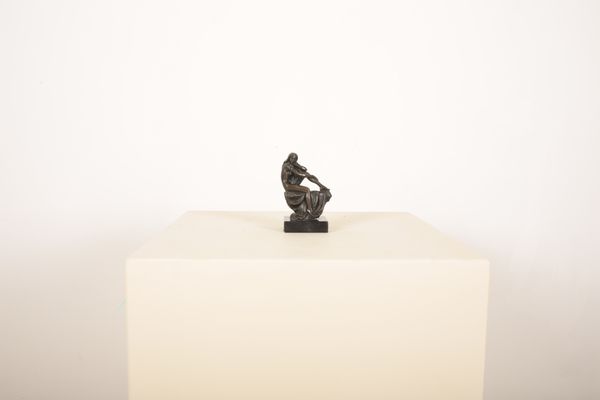A SEATED PATINATED BRONZE NUDE LADY