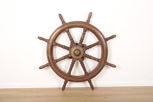 A LARGE OAK AND BRASS BOUND SHIP'S WHEEL