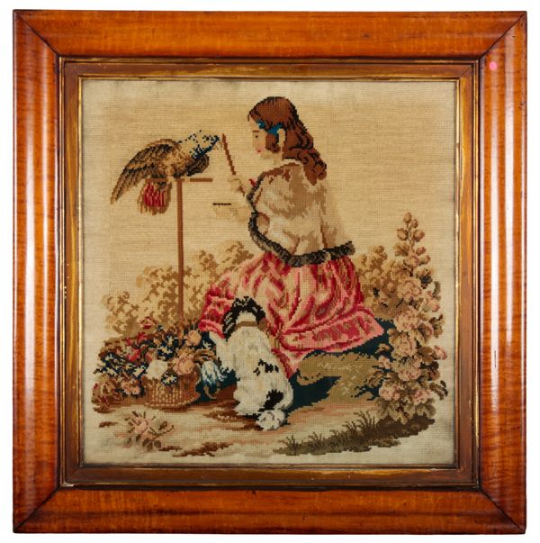 A VICTORIAN WOOL WORK PICTURE OF A LADY WITH HER SPANIEL AND PARROT