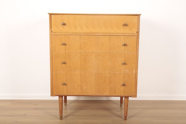 A MID CENTURY BLOND WOOD CHEST OF DRAWERS