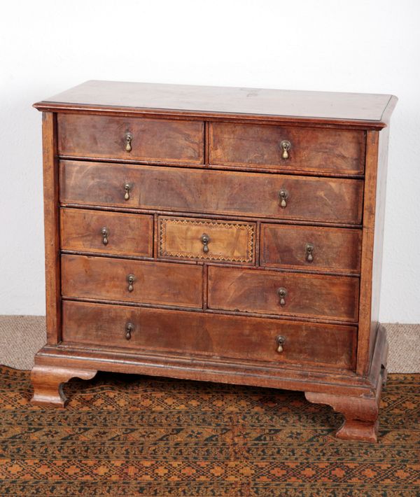 A WALNUT AND PARQUETRY CHEST OF DRAWERS