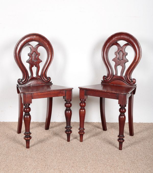 A PAIR OF VICTORIAN MAHOGANY BALLOON BACK HALL CHAIRS