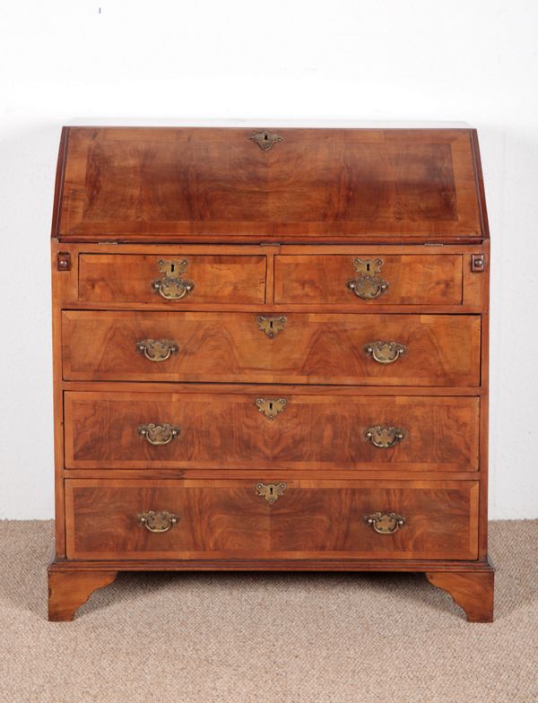 A GEORGE II STYLE FIGURED WALNUT BUREAU