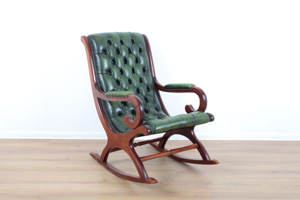 A MAHOGANY FRAMED AND GREEN LEATHER BUTTON-BACK ROCKING CHAIR