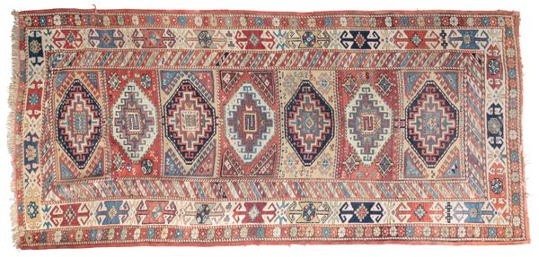 AN ANTIQUE KAZAK LONG RUG