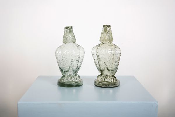 A PAIR OF 'MOHAN MEAKIN KENYA' PRESSED GLASS EAGLE WHISKEY DECANTERS