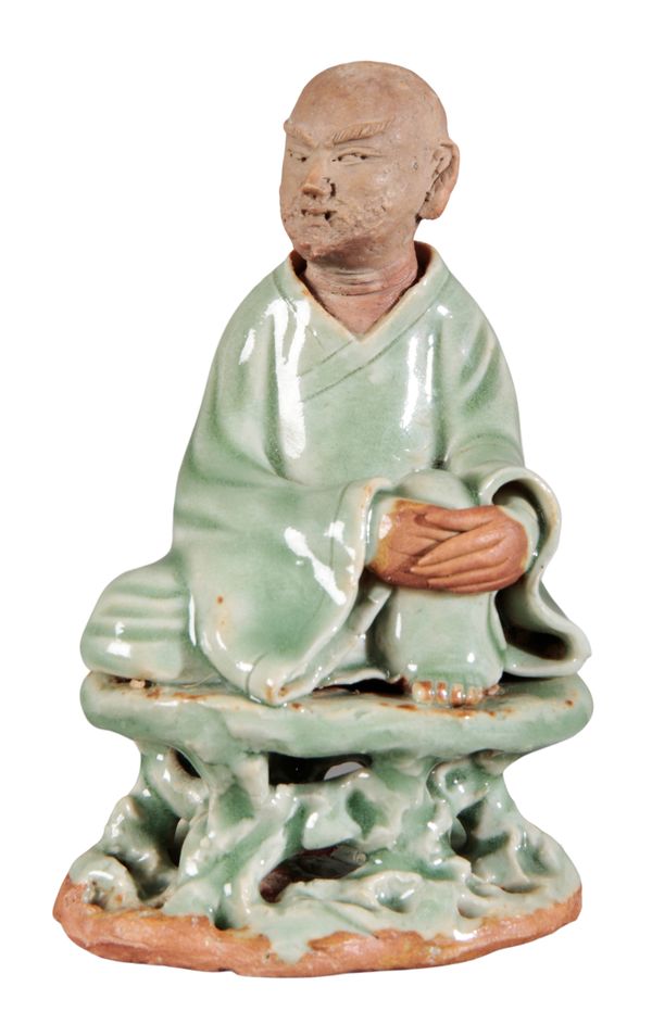 A CHINESE TERRACOTTA AND LONGQUAN CLEADON GLAZED FIGURE