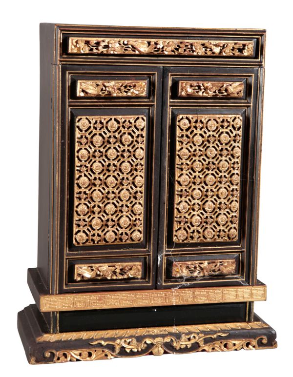 A CHINESE BLACK LACQUER AND PARCEL GILT SHRINE CABINET