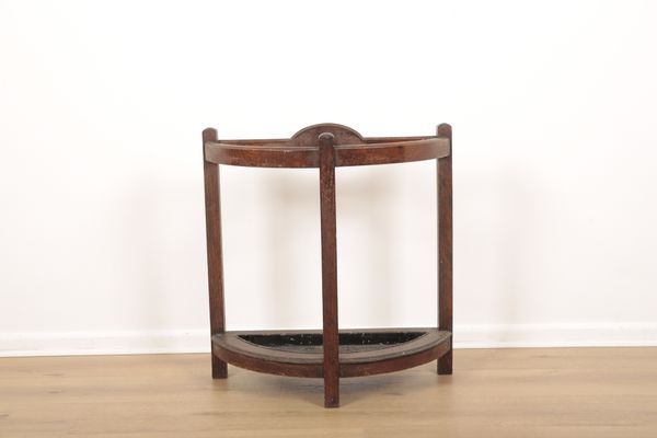 AN EDWARDIAN OAK DEMI-LUNE UMBRELLA STAND