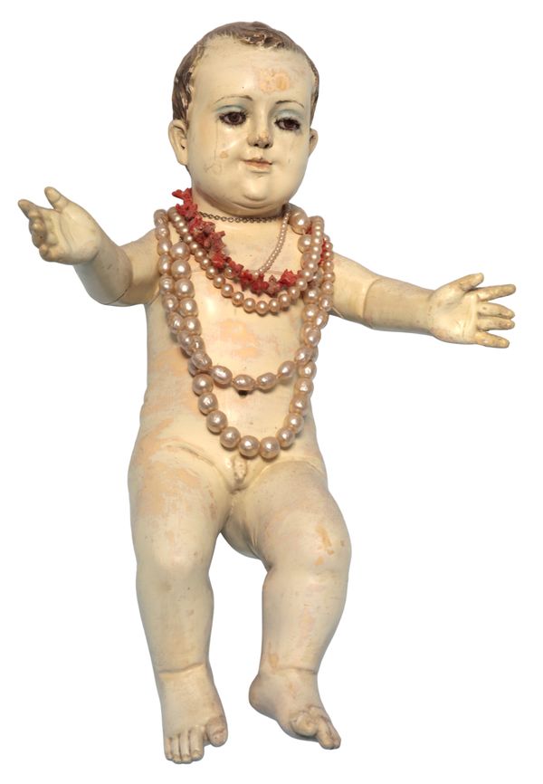 A CONTINENTAL PAINTED LIMEWOOD FIGURE OF THE INFANT CHRIST
