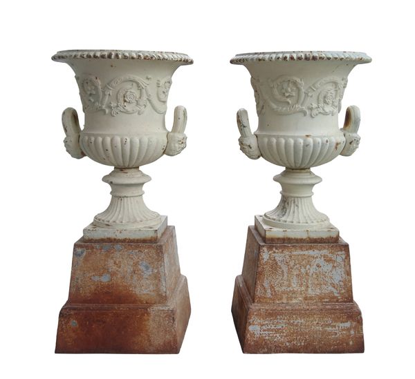 A PAIR OF CAST IRON CAMPANA GARDEN URNS WITH STEPPED PEDESTAL