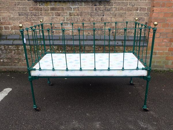 A VICTORIAN IRON COT, WITH BRASS KNOBS