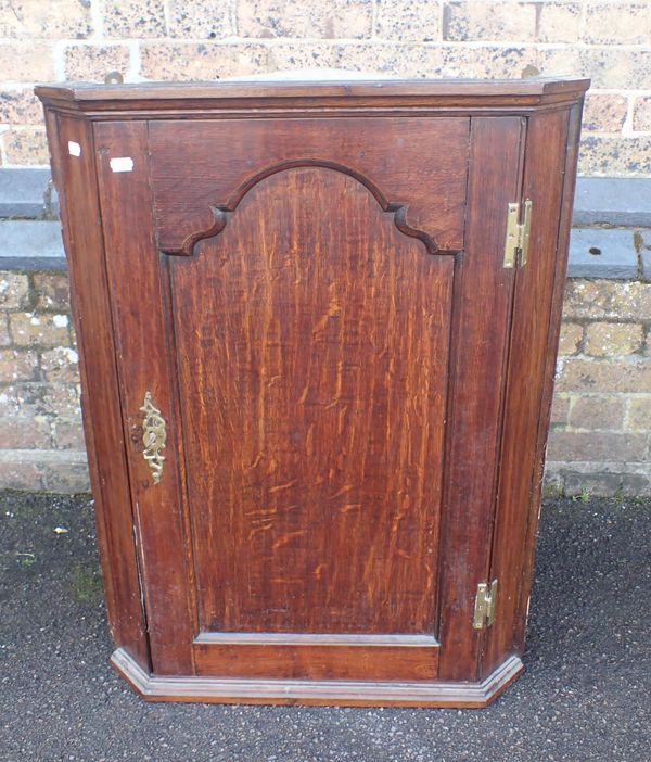 A GEORGE III OAK CORNER CUPBOARD