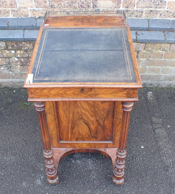 A VICTORIAN FIGURED WALNUT DAVENPORT