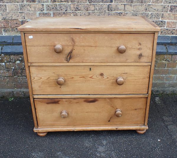 A STRIPPED PINE CHEST OF THREE DRAWERS