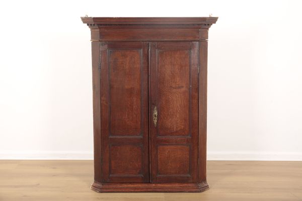 AN ENGLISH OAK CORNER CUPBOARD