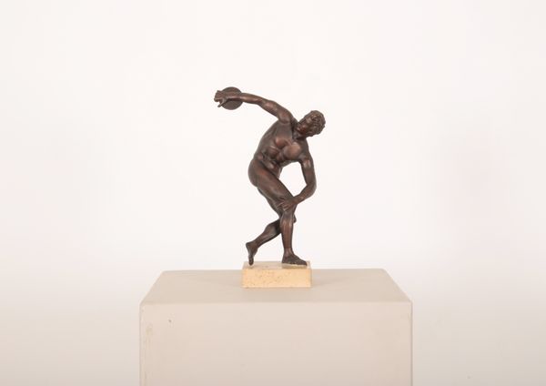 A PATINATED RESIN SCULPTURE OF THE DISCUS THROWER AFTER THE ANTIQUE