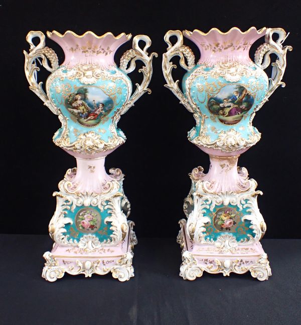 A PAIR OF PORCELAIN URNS ON STANDS, POSSIBLY DRESDEN