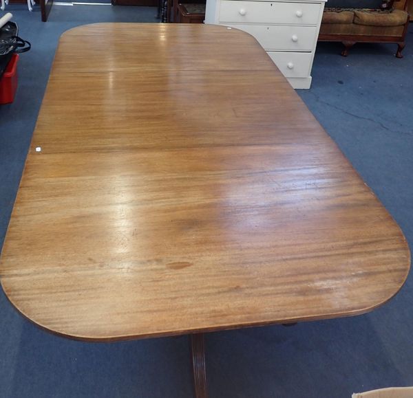 A GEORGE III STYLE MAHOGANY TWIN-PILLAR DINING TABLE