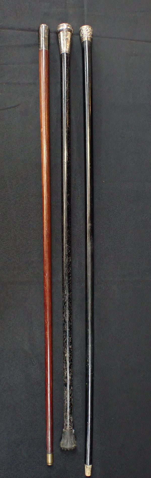 THREE WHITE METAL TOPPED WALKING CANES