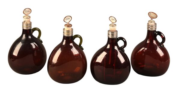 A SET OF FOUR EARLY VICTORIAN AMBER GLASS SPIRIT FLASKS